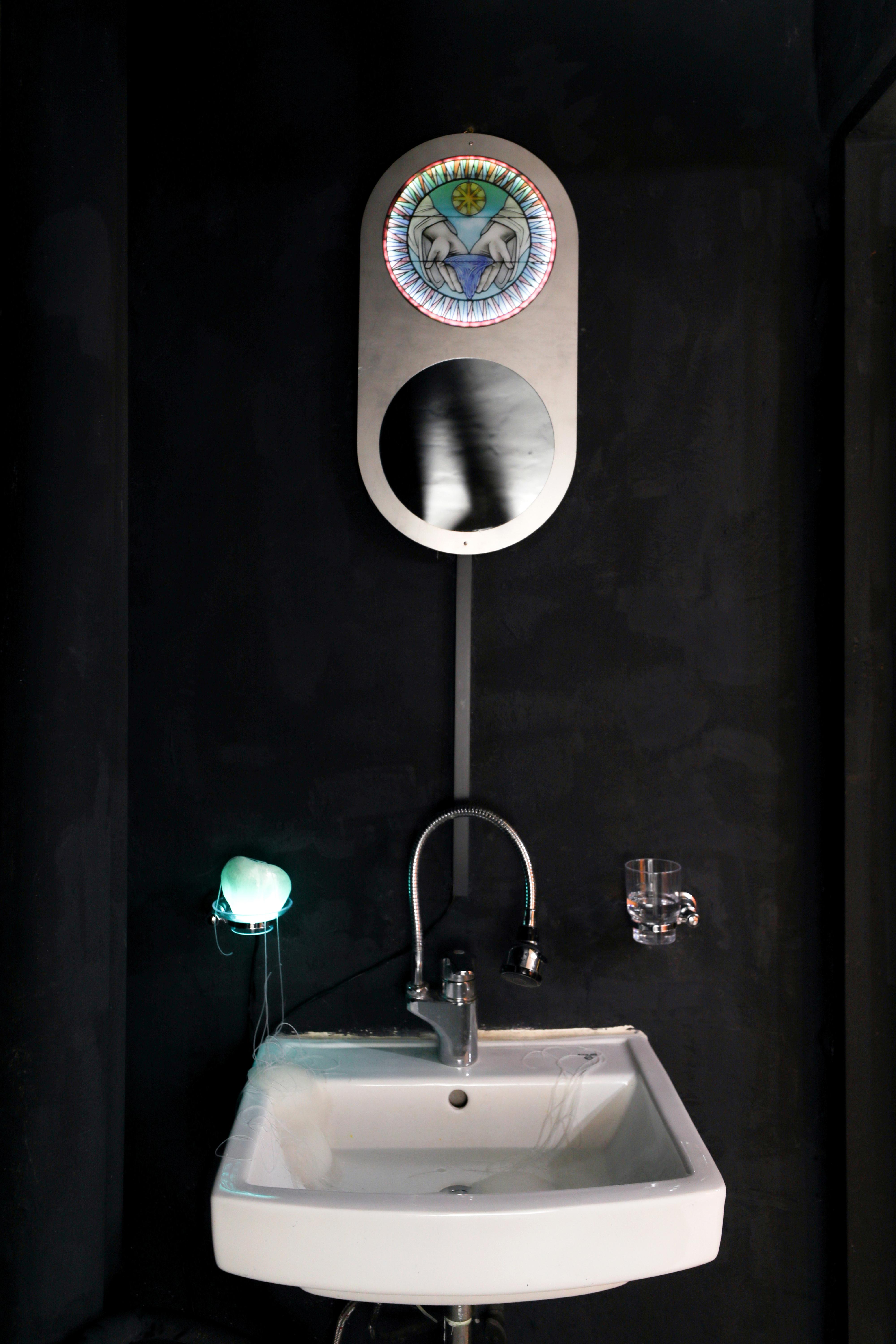 a sink with a catholic fixture above it